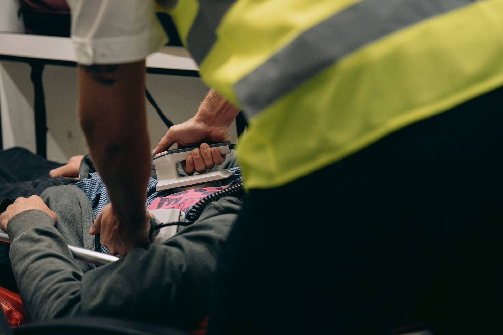 Paramedics provide urgent care to a patient on a stretcher during an emergency situation.
