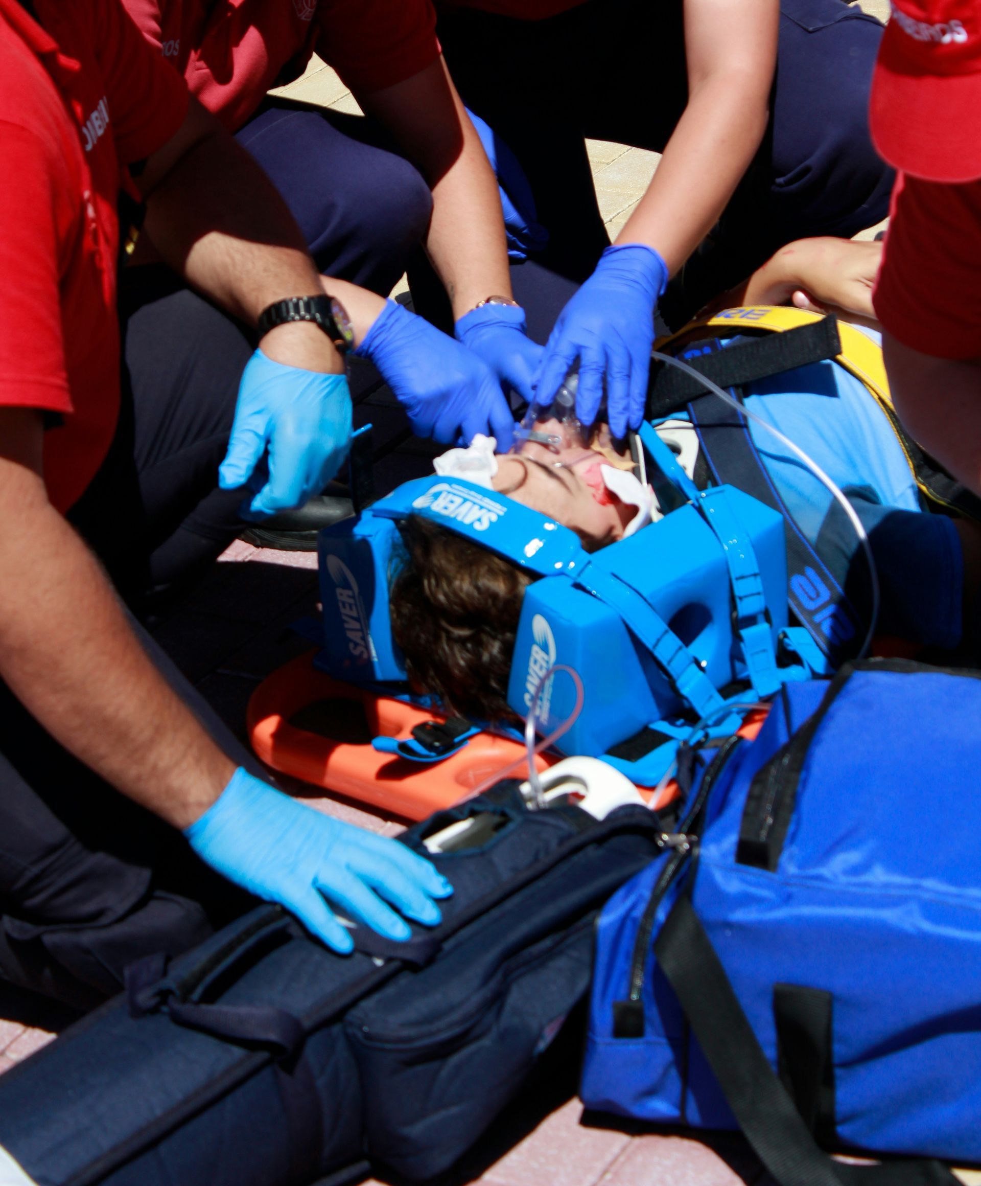people performing first aid medical care to an injured man